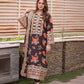 Woman wearing a floral embroidered dress standing outdoors. House Of Beenora | Best women clothing brand in Pakistan
