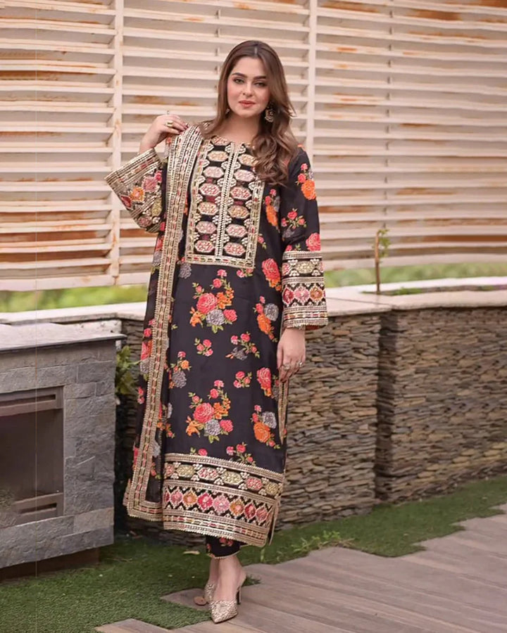 Woman wearing a floral embroidered dress standing outdoors. House Of Beenora | Best women clothing brand in Pakistan