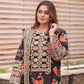 Woman wearing a black embroidered outfit with floral patterns against a wooden background