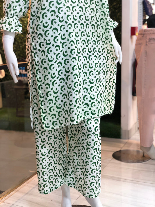 Green and white patterned outfit on a mannequin in a store setting