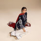 Woman wearing a traditional outfit with a red dupatta and white pants on a beige background