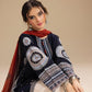 Woman wearing a traditional embroidered outfit with a red scarf on a beige background