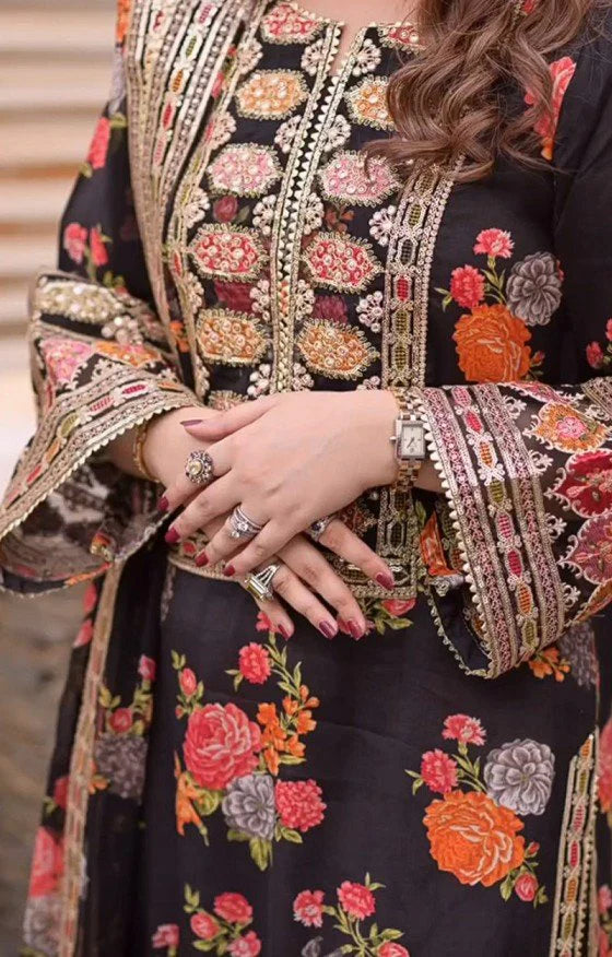 Close-up of a person wearing a black embroidered outfit with colorful floral patterns. House Of Beenora | Best women clothing brand in Pakistan