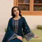 Woman in a dark blue embroidered traditional outfit sitting on a green chair.