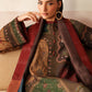 Woman wearing a traditional embroidered outfit with a red dupatta, sitting on a beige couch.